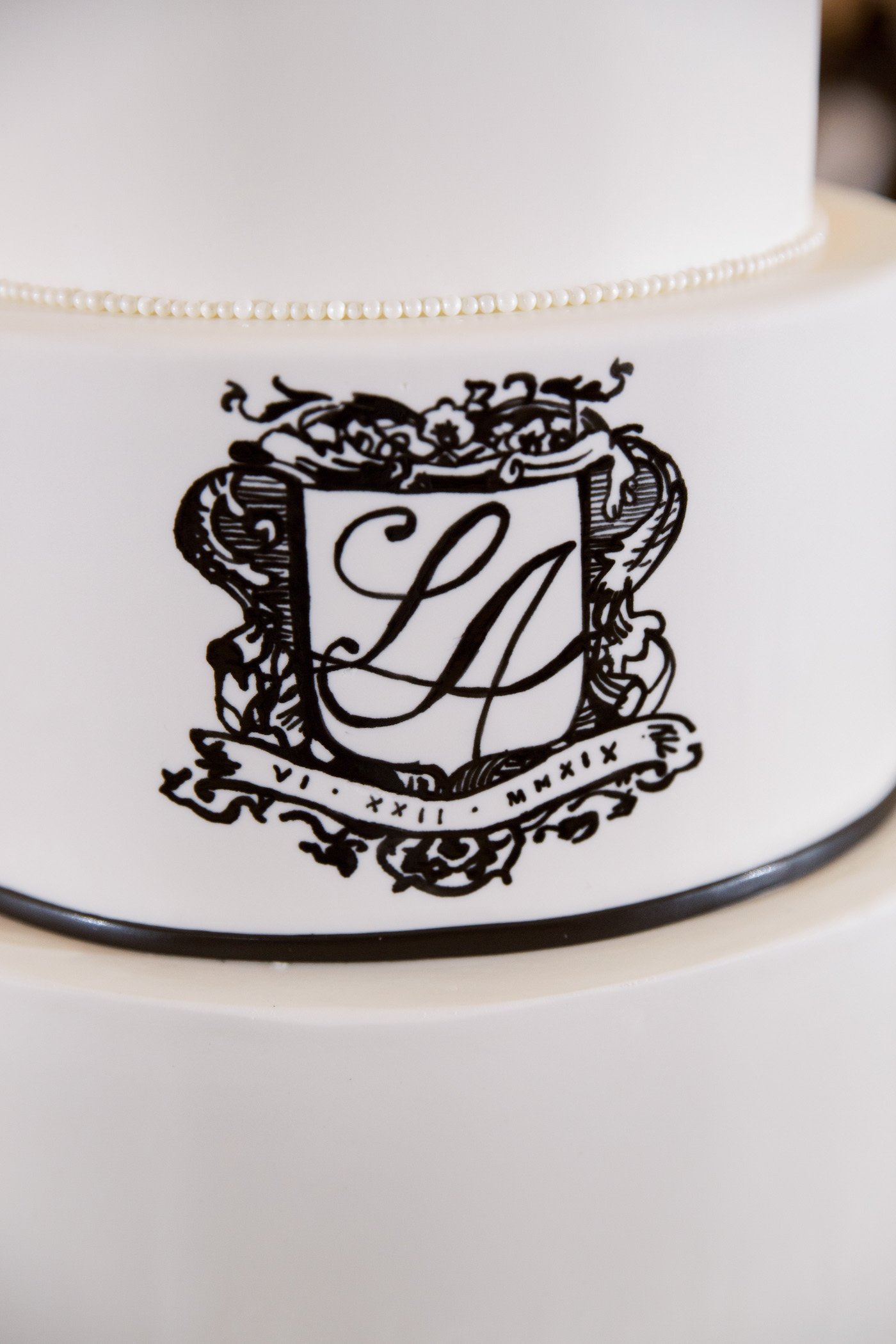 Family Emblem on Black and White Wedding Cake Inspiration | Tampa Bay Planner Parties A La Carte
