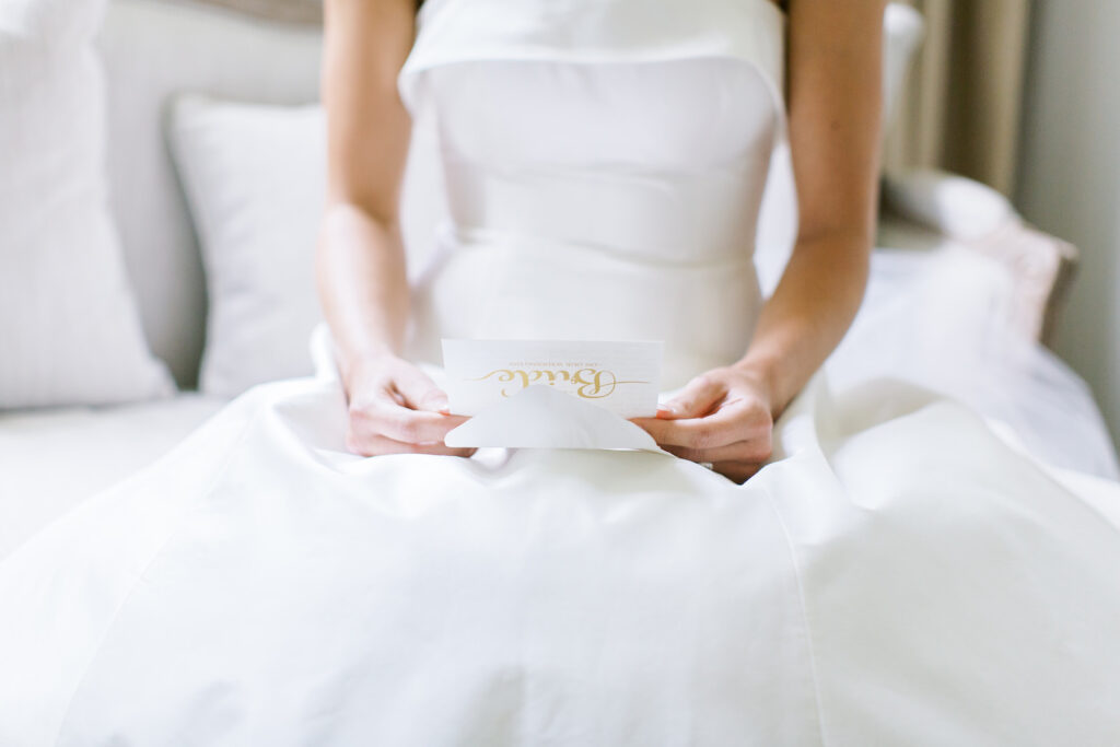 Classic Black and White Wedding Inspiration | Bride Reading Letter From Groom on Wedding Day