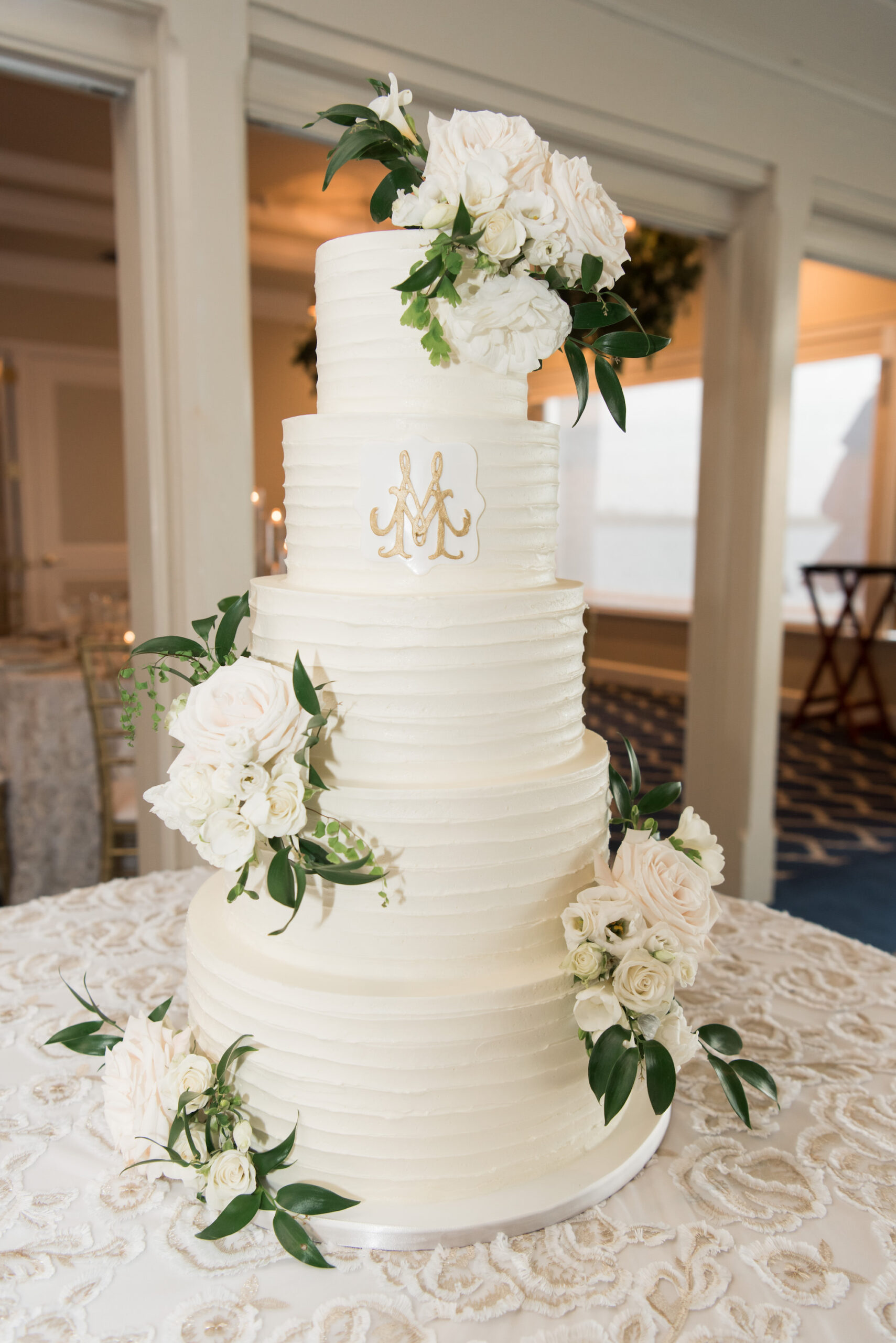 Five Tiered Round White Buttercream Wedding Cake with White Roses and Greenery Accents | Timeless Wedding Reception Dessert Table Inspiration
