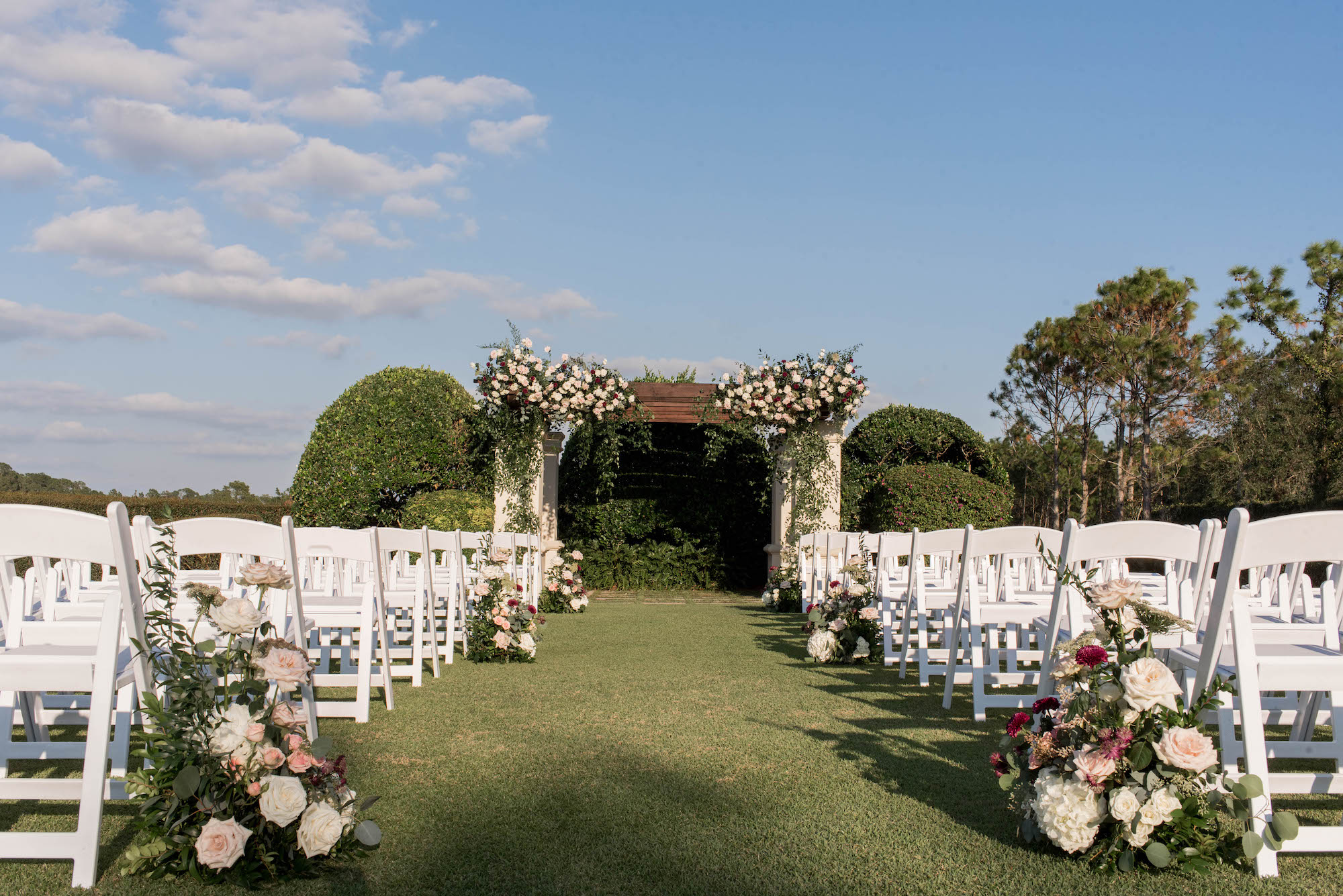 Outdoor Wedding Ceremony with White Folding Garden Chairs and Pergola Arch Inspiration | Tampa Bay Event Planner Parties A La Carte